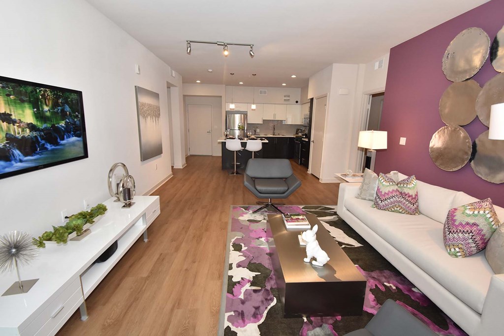 A modern living room with a white couch and a coffee table.