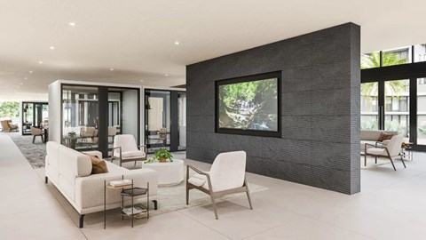 A modern living room with a white sofa set and a large painting on the wall.