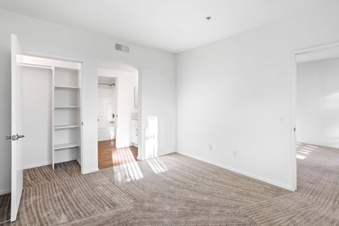 A large, empty room with a carpeted floor and white walls.at Costa Verde Village Apartments, San Diego, CA 92122