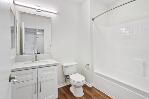 A white bathroom with a toilet, sink, and bathtub.at Costa Verde Village Apartments, San Diego, 92122