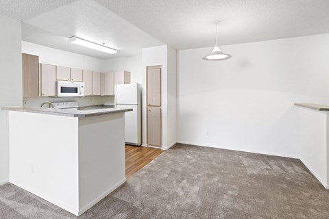 A kitchen with white cabinets and appliances.at Costa Verde Village Apartments, San Diego California
