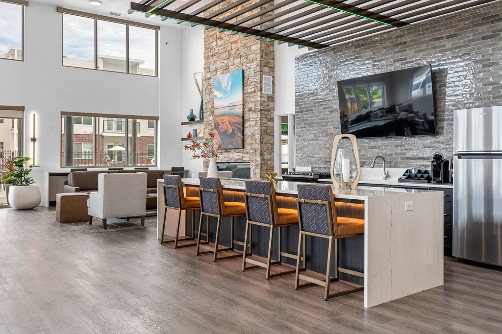 a kitchen with a large center island next to a living room