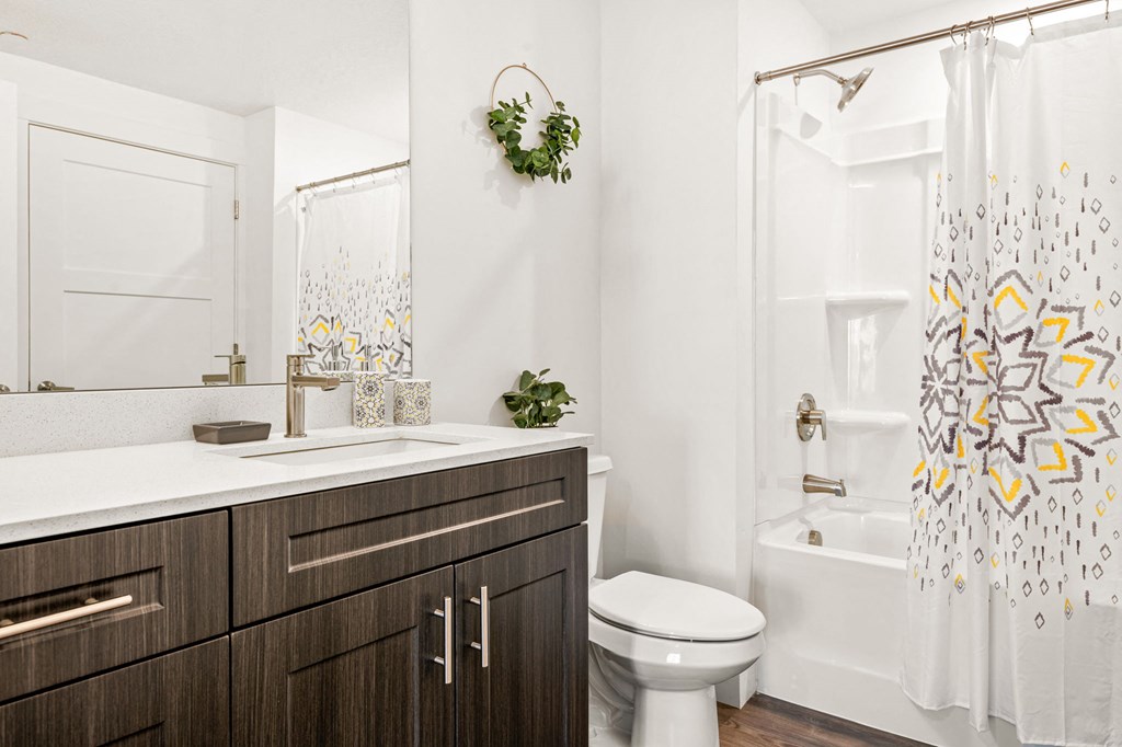 a bathroom with dark wood cabinets and a white toilet