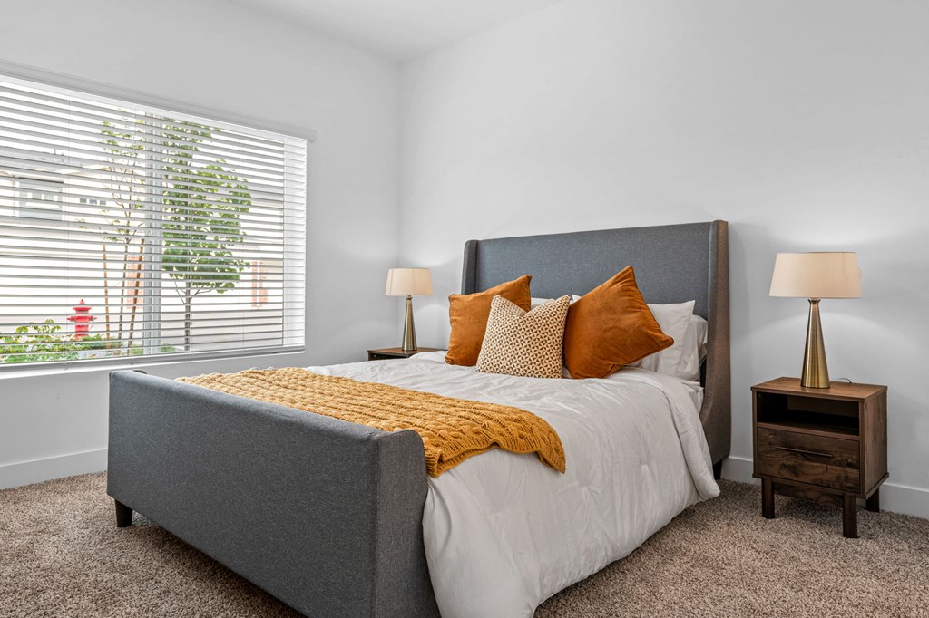 a bedroom with a bed and two night stands with lamps