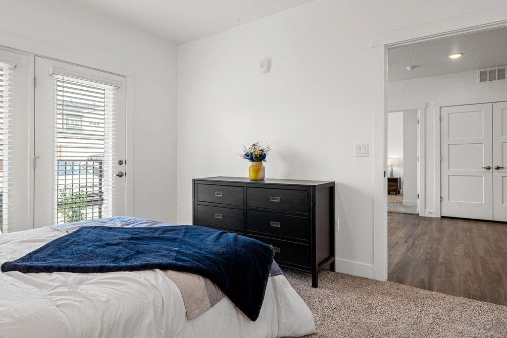 a bedroom with a bed and a dresser