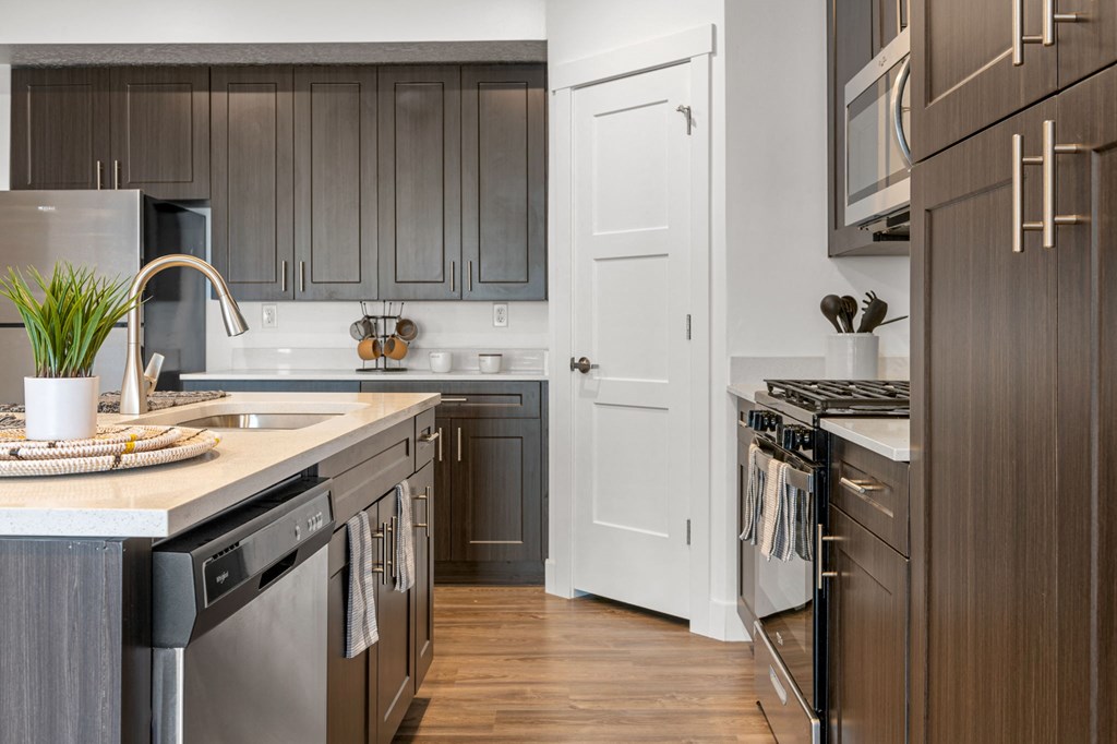 a kitchen with gray cabinets and a white door