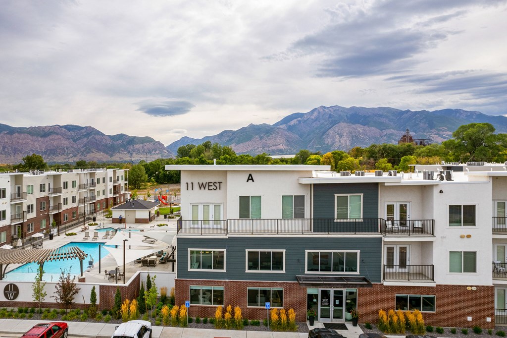 an aerial view of the in west apartments with a pool and mountains in the background