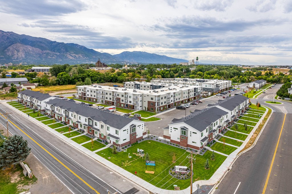 arial view of a row of apartment buildings with mountains in the background