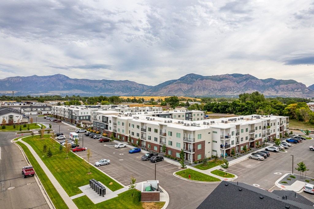 an aerial view of an apartment complex with a mountain range in the background