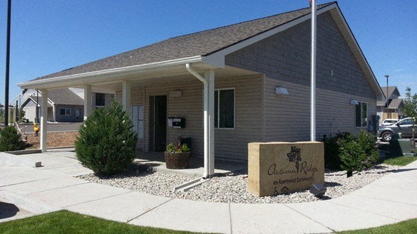 A building with a sign that says "Ascension Retreat" in front of it.