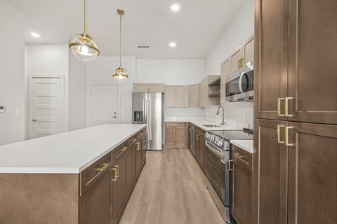 A kitchen with brown cabinets and a white countertop.