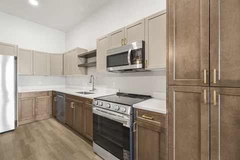 A kitchen with wooden cabinets and a stainless steel refrigerator.