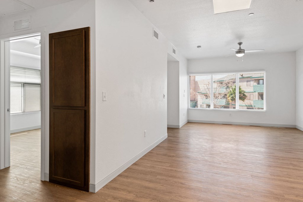 a bedroom with hardwood floors and white walls