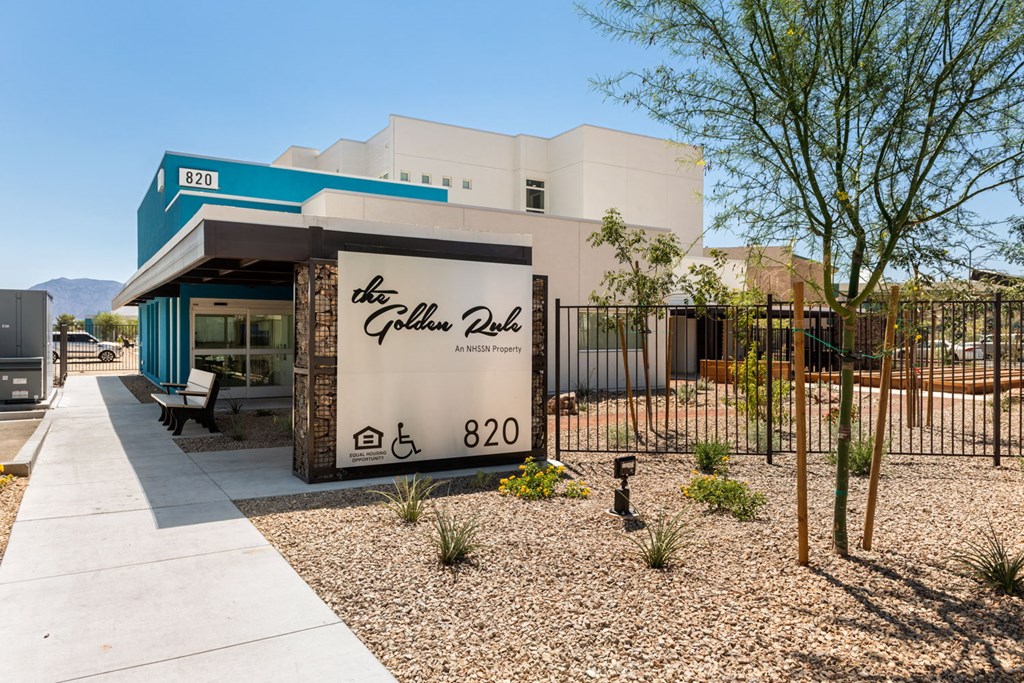 a building with a sign that reads the golden pass in front of it
