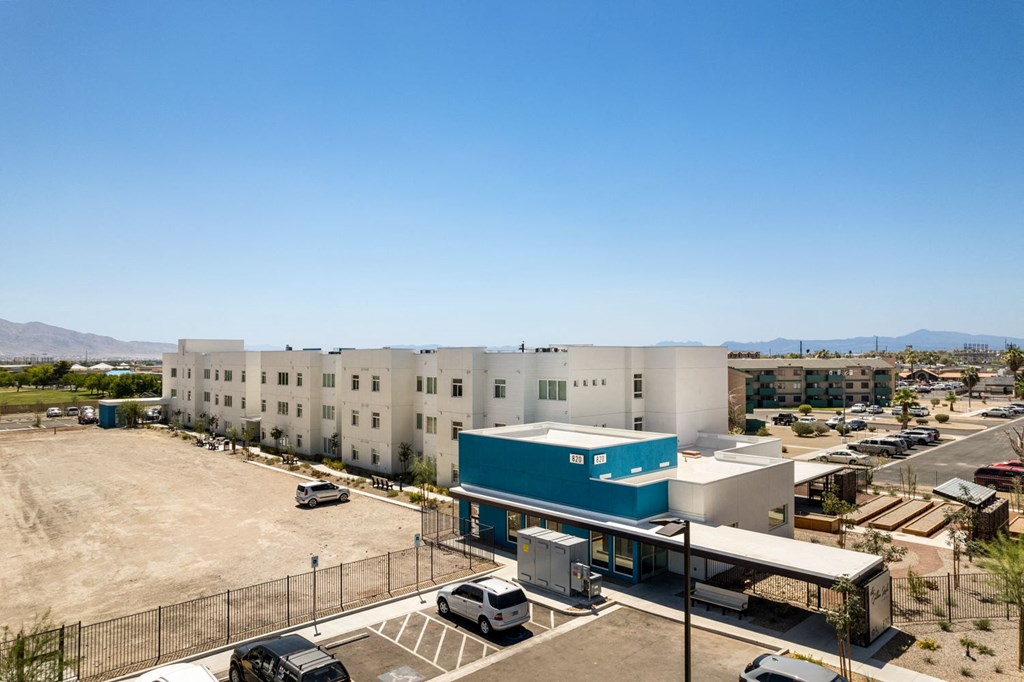 a large white building with a blue building in front of it