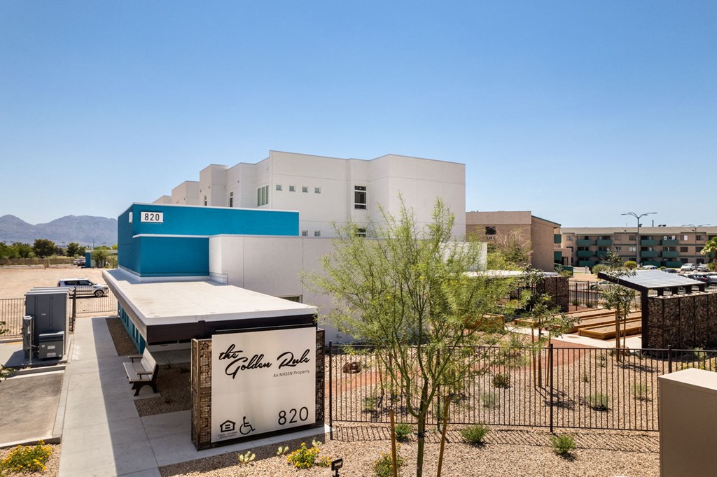 a white and blue building with a black and white sign in front of it