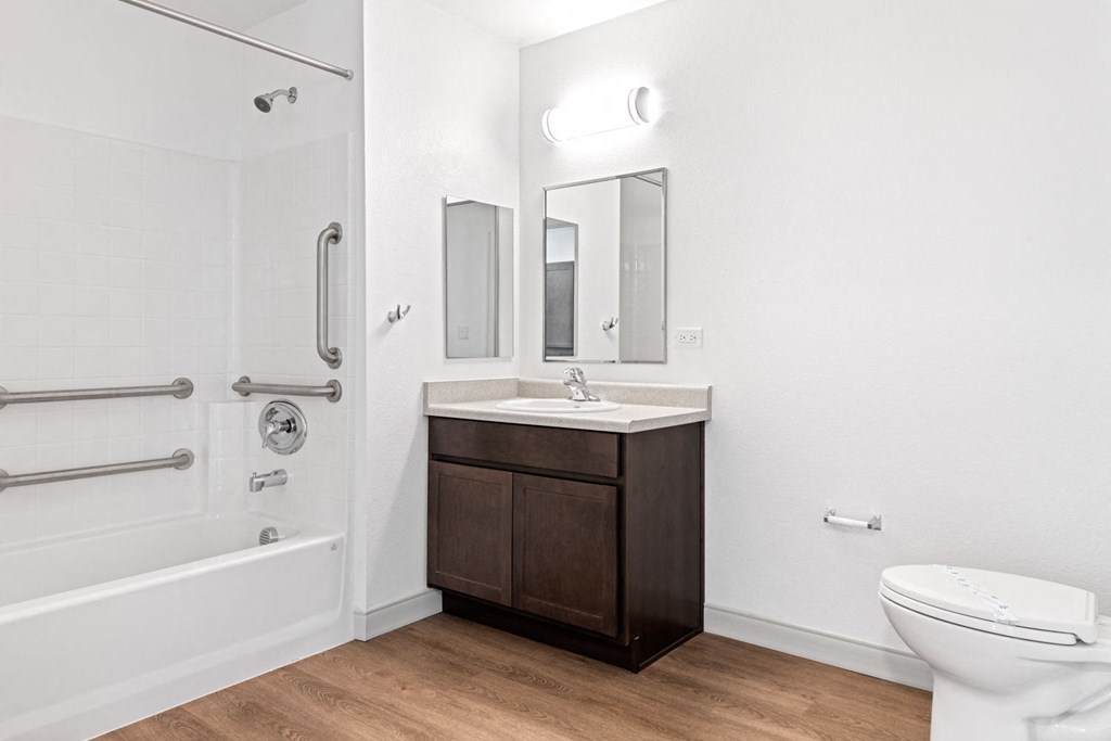 a bathroom with a toilet sink and shower