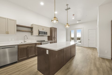 A modern kitchen with wooden cabinets and a central island.