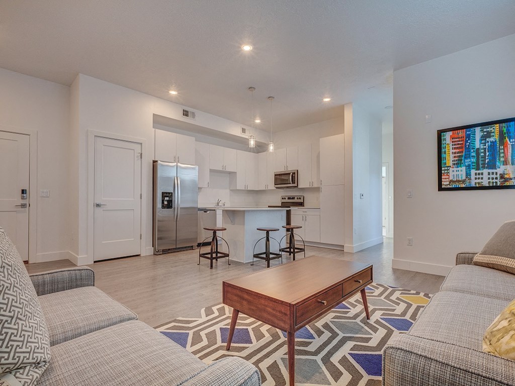 A modern living room with a grey sofa and a wooden coffee table.