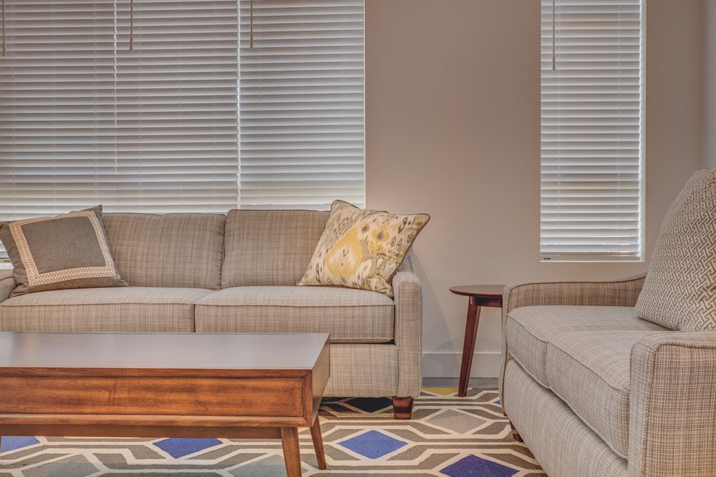 A living room with a couch, chair, and coffee table.