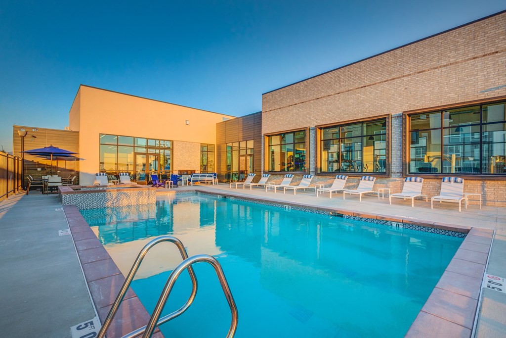 A large swimming pool with a metal ladder in the middle of it.
