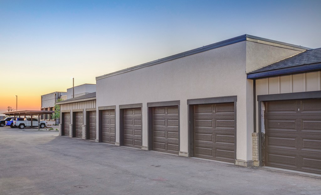 A building with a row of garage doors in front of it.