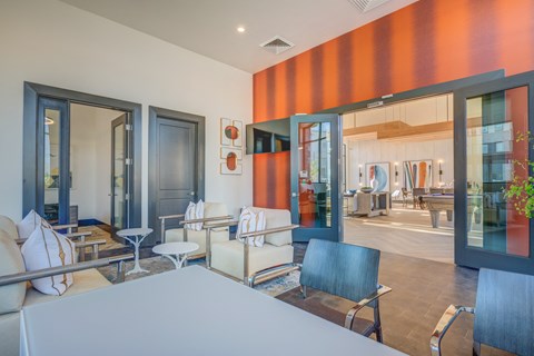 A modern living room with a grey sofa and a glass table.