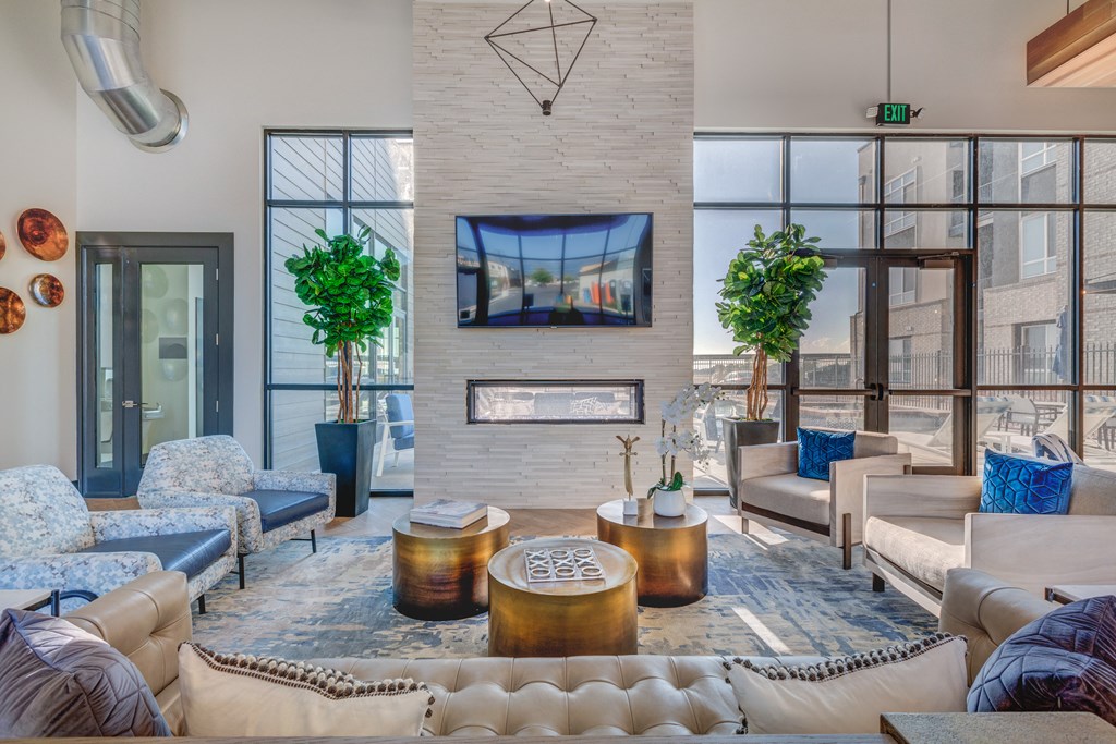 A living room with a large couch, a TV, and a fireplace.
