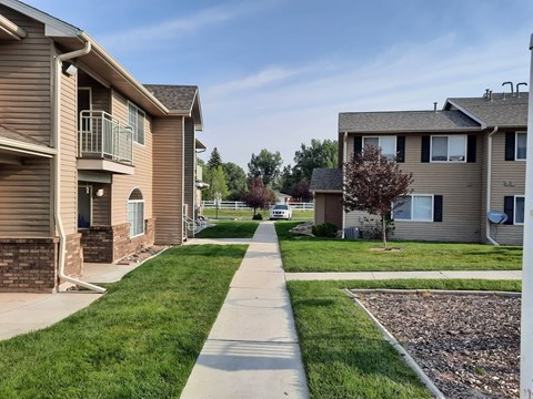 A residential area with houses and a sidewalk.