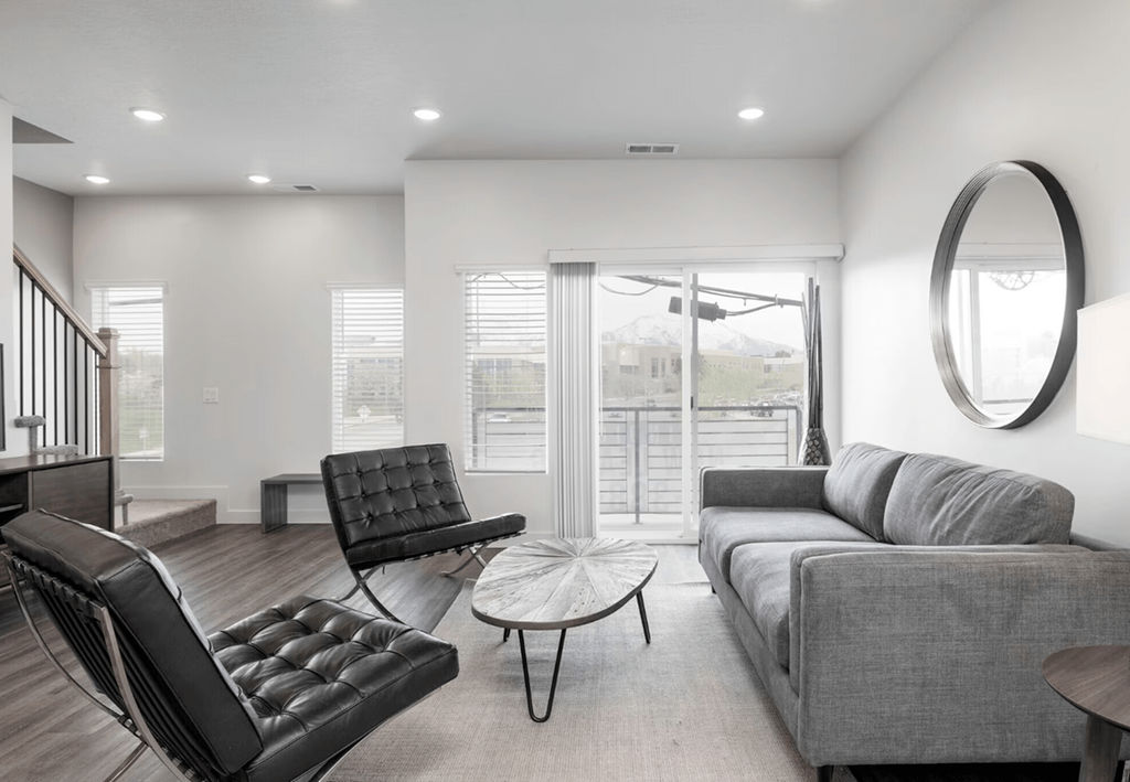 a living room with a couch and a chair and a table