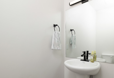 a white bathroom with a sink and a mirror