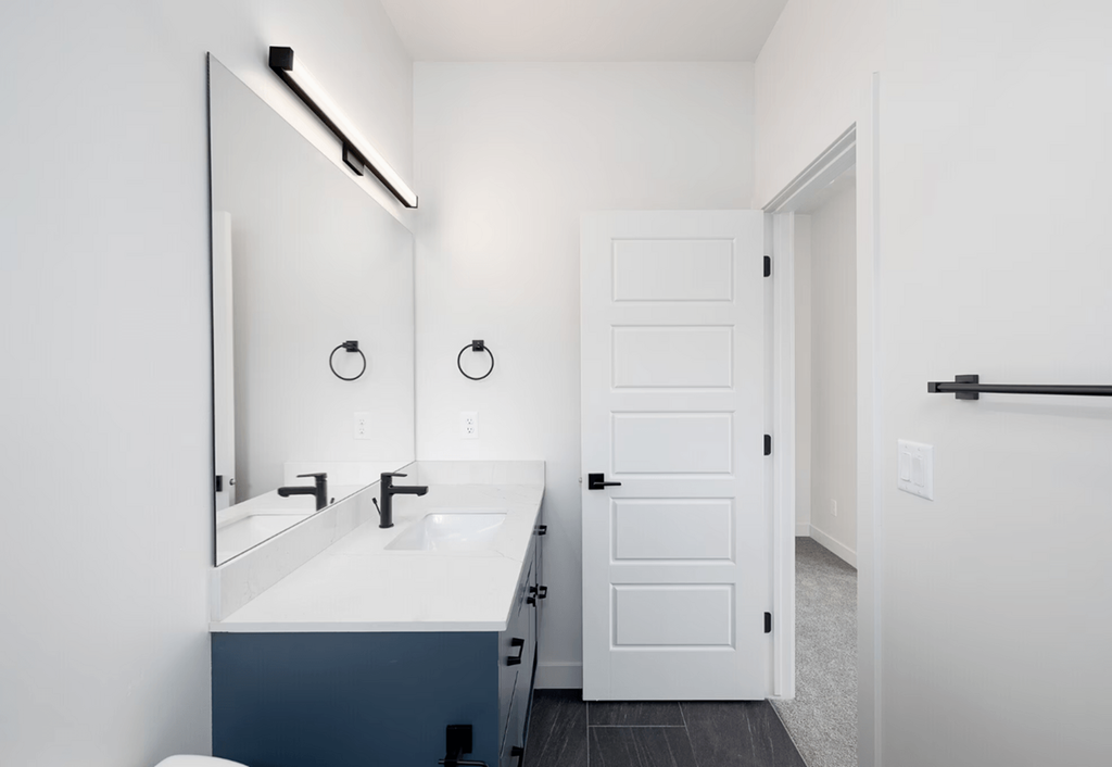 a white bathroom with a sink and a mirror
