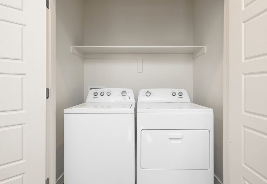 a washer and dryer in a laundry room with white doors