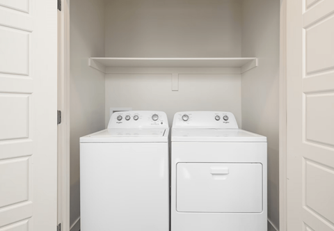 a washer and dryer in a laundry room with white doors
