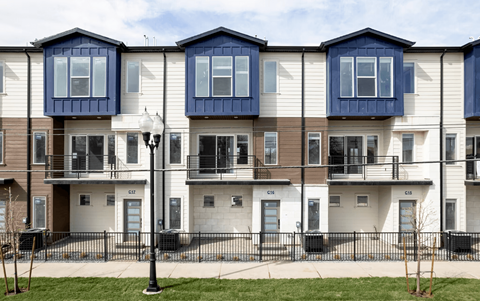 a row of town houses with blue and white roofs