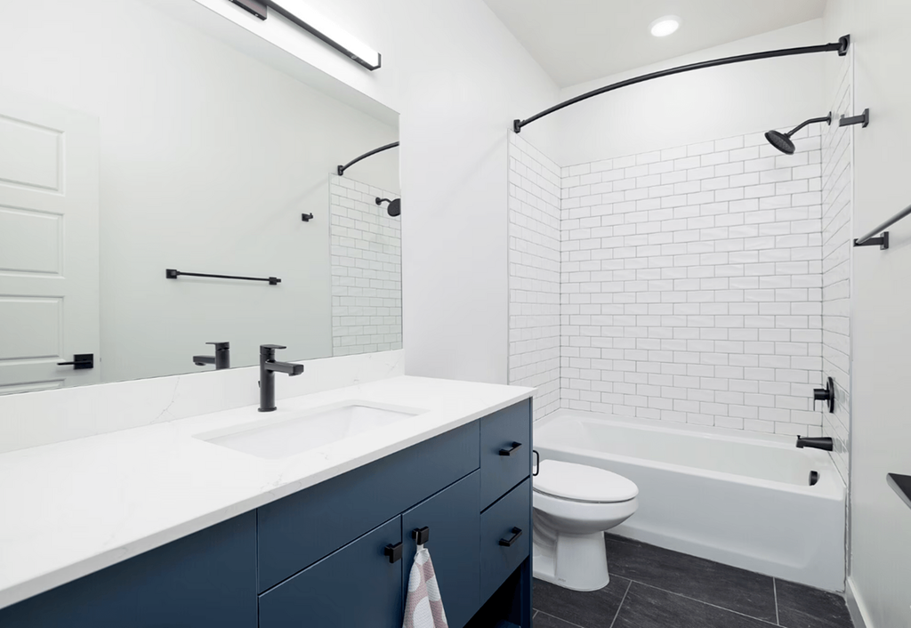 a white bathroom with a sink and a toilet