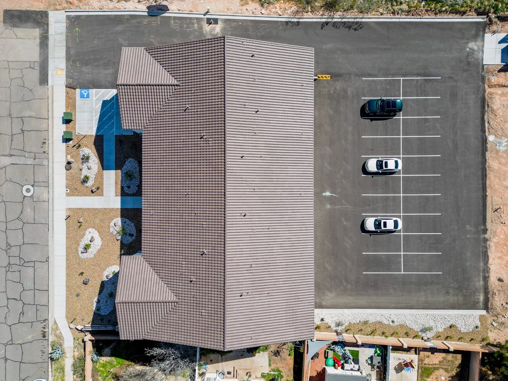 a house with a brown roof and a parking lot