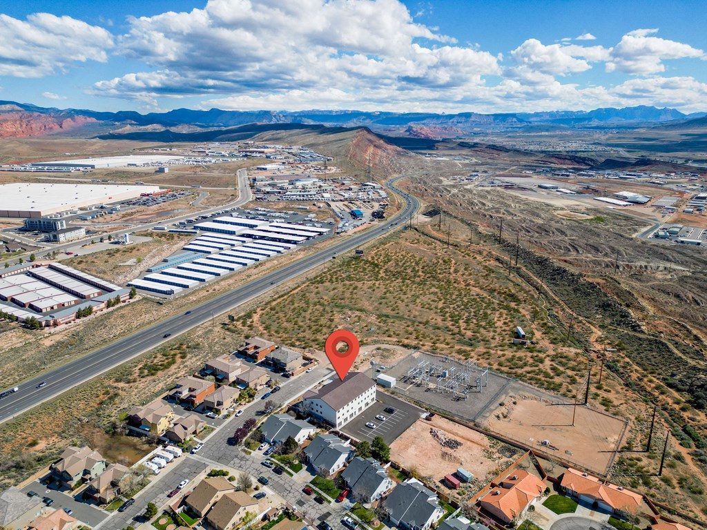 an aerial view of a city with an arrow pinpointing the location of a building