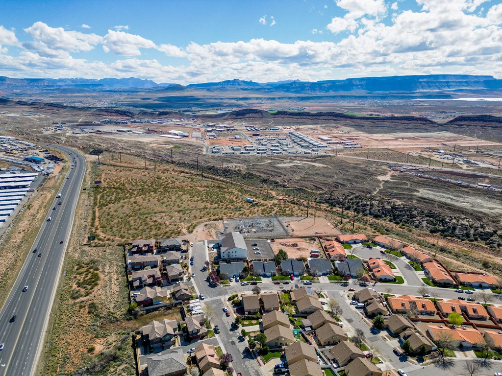 an aerial view of a city with a highway and residential neighborhoods