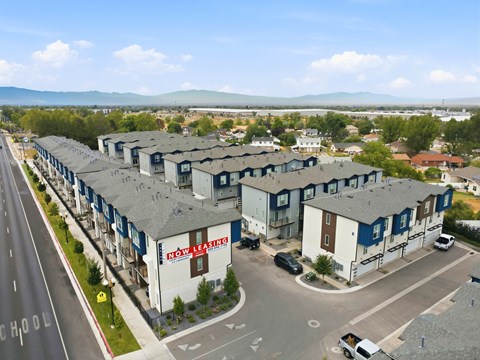 A view of a road with a building that has a sign that says "ROW LEASING".