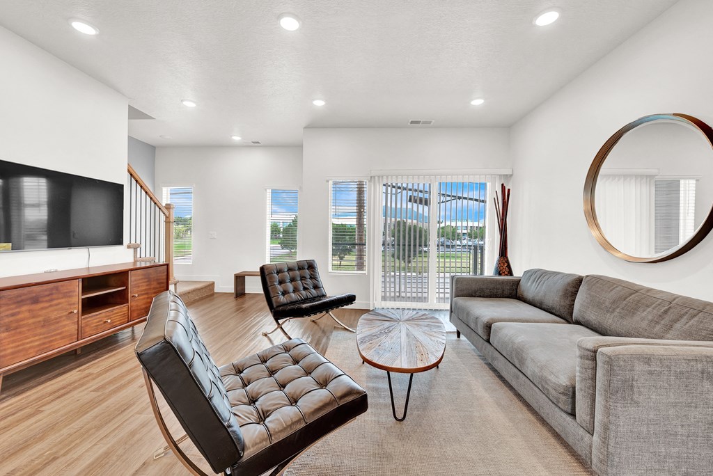 a living room with a couch and a chair and a television