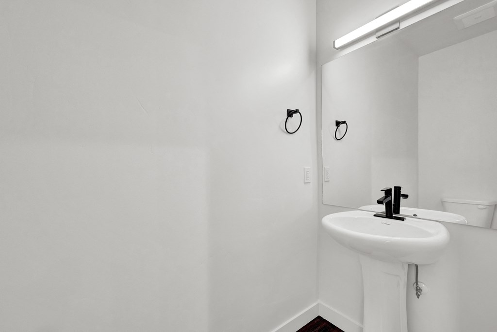 an empty bathroom with a sink and a mirror