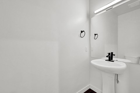 an empty bathroom with a sink and a mirror