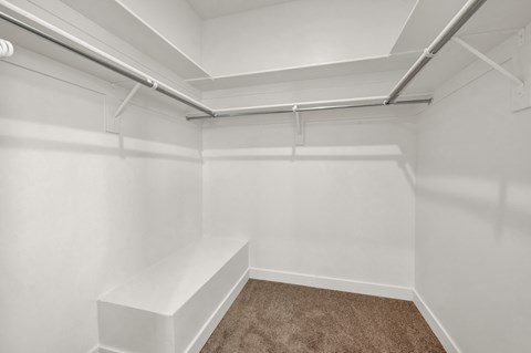 a empty white room with white walls and a brown carpet