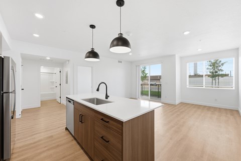 A modern kitchen with wooden cabinets and a white countertop.