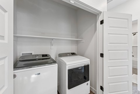 A white kitchen with a dishwasher and a microwave.