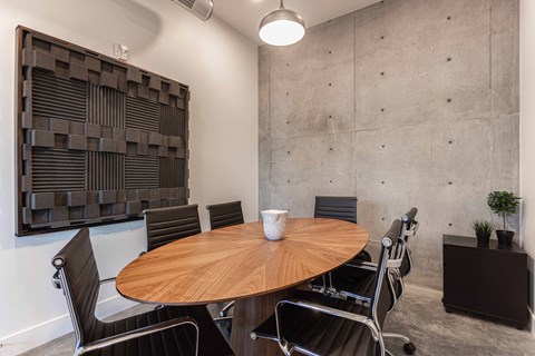 a meeting room with a wooden table and chairs