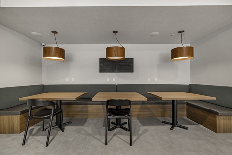 A modern dining area with a long table and chairs.