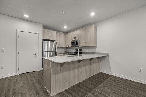 A kitchen with wooden cabinets and a white countertop.