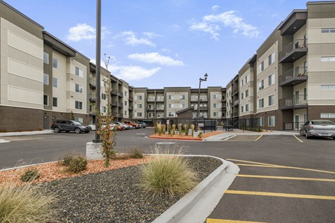 A parking lot in front of apartment buildings.